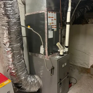 Furnace and air handler connected to insulated supply ductwork